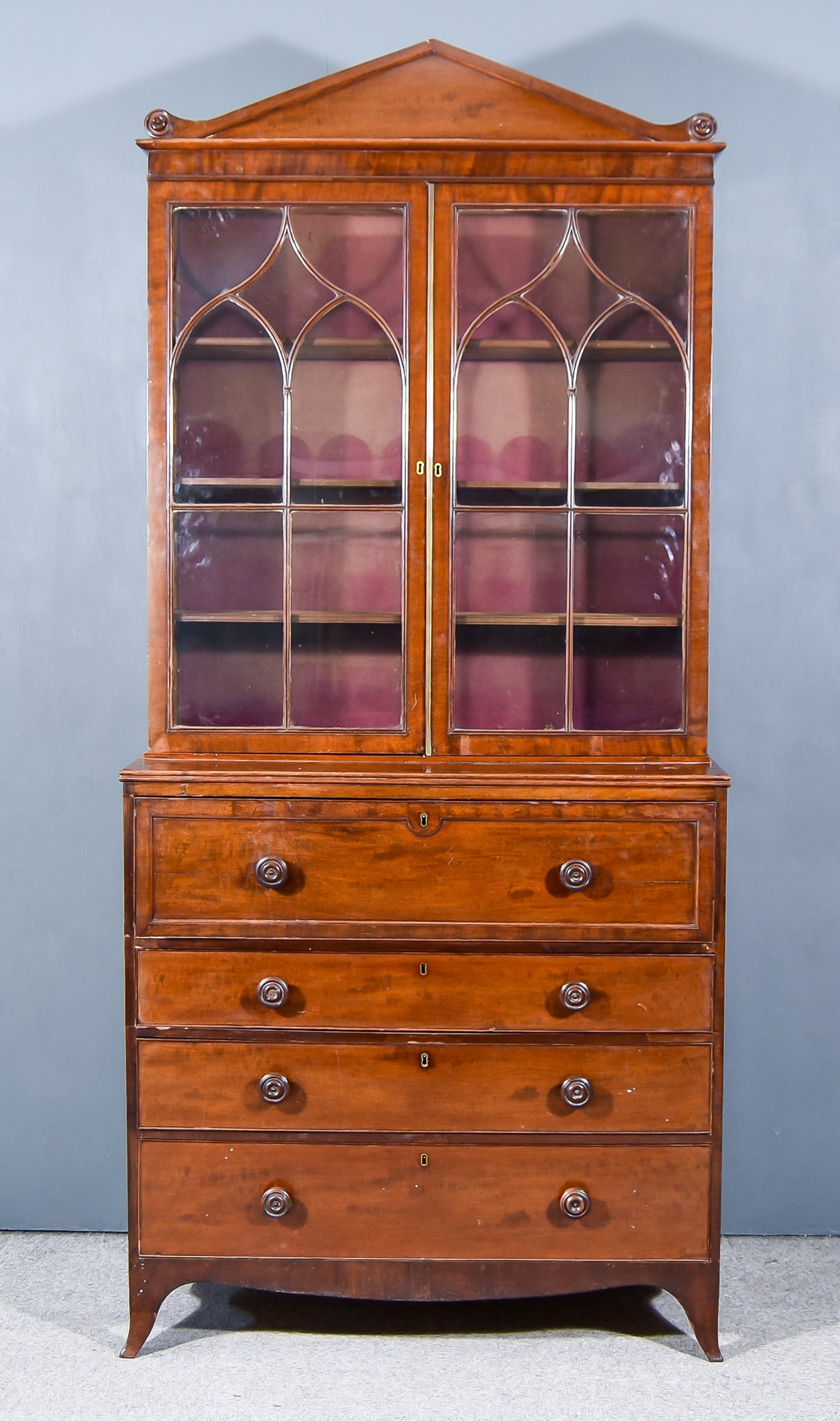 A Late Georgian Mahogany Secretaire Bookcase, the upper part with angled cornice, fitted three