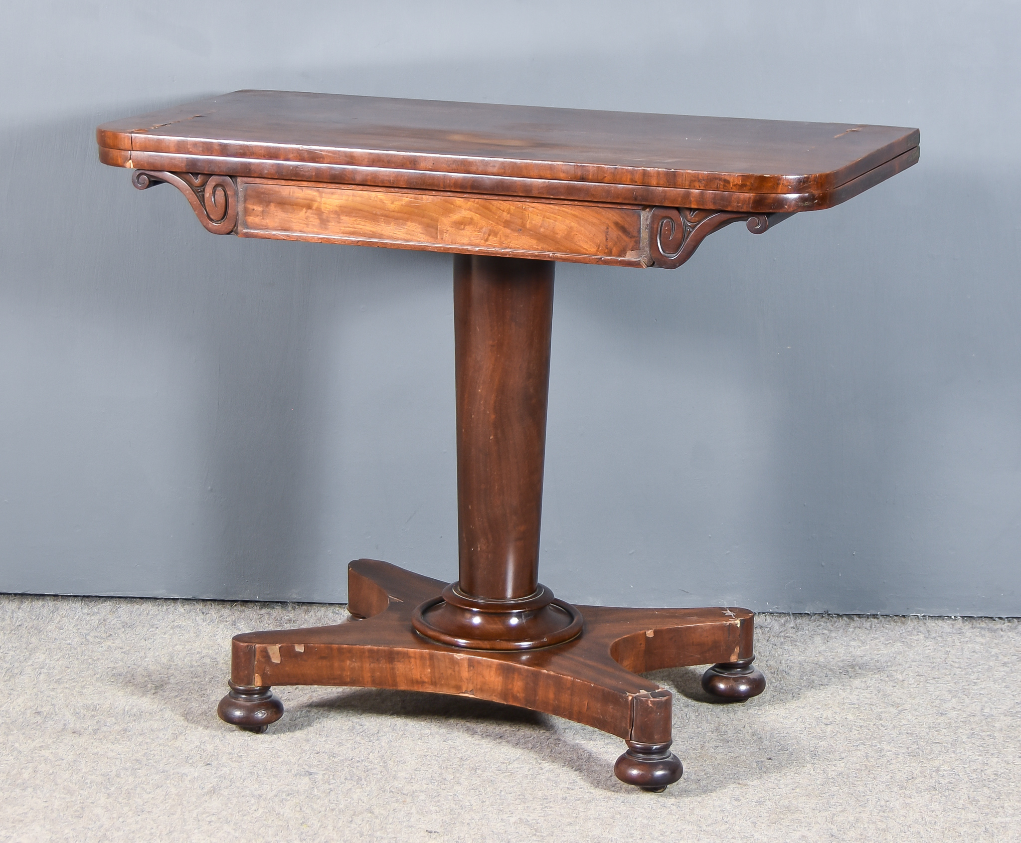 An Early 19th Century Rectangular Card Table, the baize lined folding top with rounded front