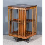 An Edwardian Mahogany Square Two Tier Revolving Bookcase, the top inlaid with fan motif to centre