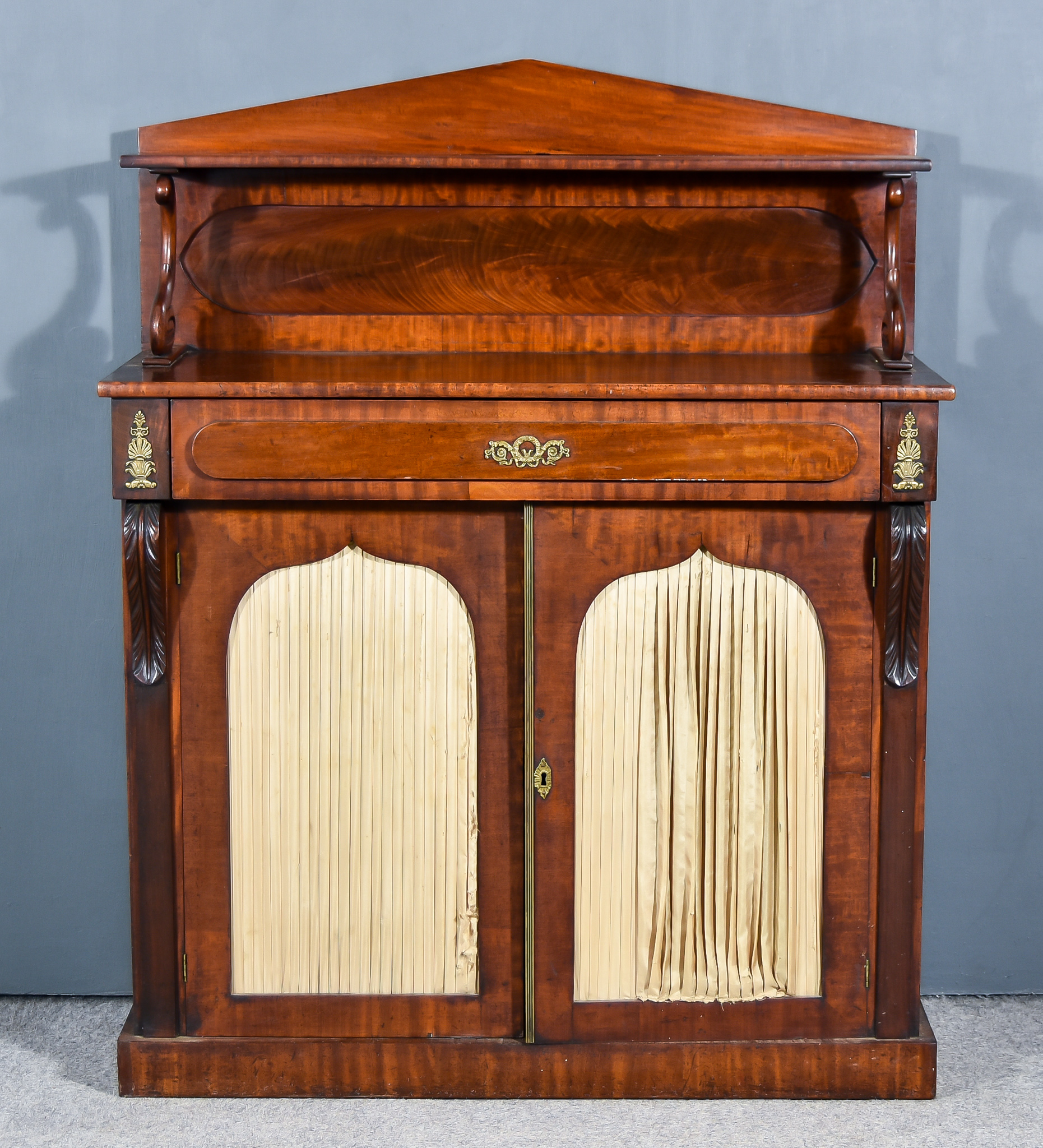 A 19th Century Mahogany Chiffonier Cabinet, the angled back fitted one open shelf on scroll