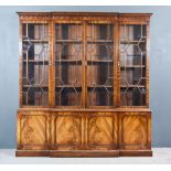 A Mahogany Break Front Bookcase of "Georgian" Design, the upper part with moulded cornice, dentil