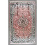 A 20th Century Pure Silk Tabriz Carpet, woven in pastel shades, with a bold central floral medallion