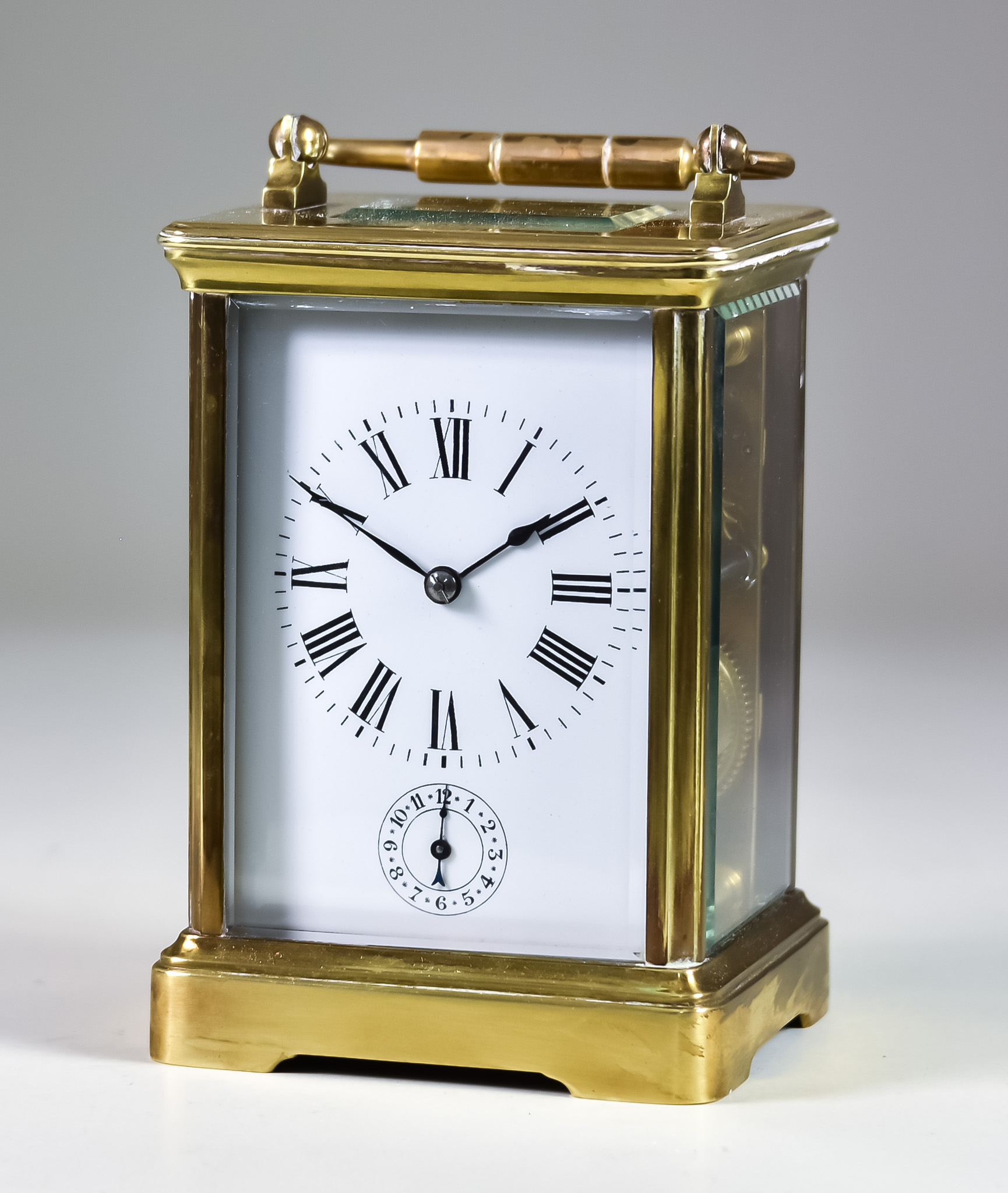 A Late 19th/Early 20th Century Brass Cased Carriage Clock, the white enamel dial with Roman numerals