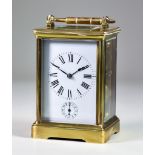 A Late 19th/Early 20th Century Brass Cased Carriage Clock, the white enamel dial with Roman numerals