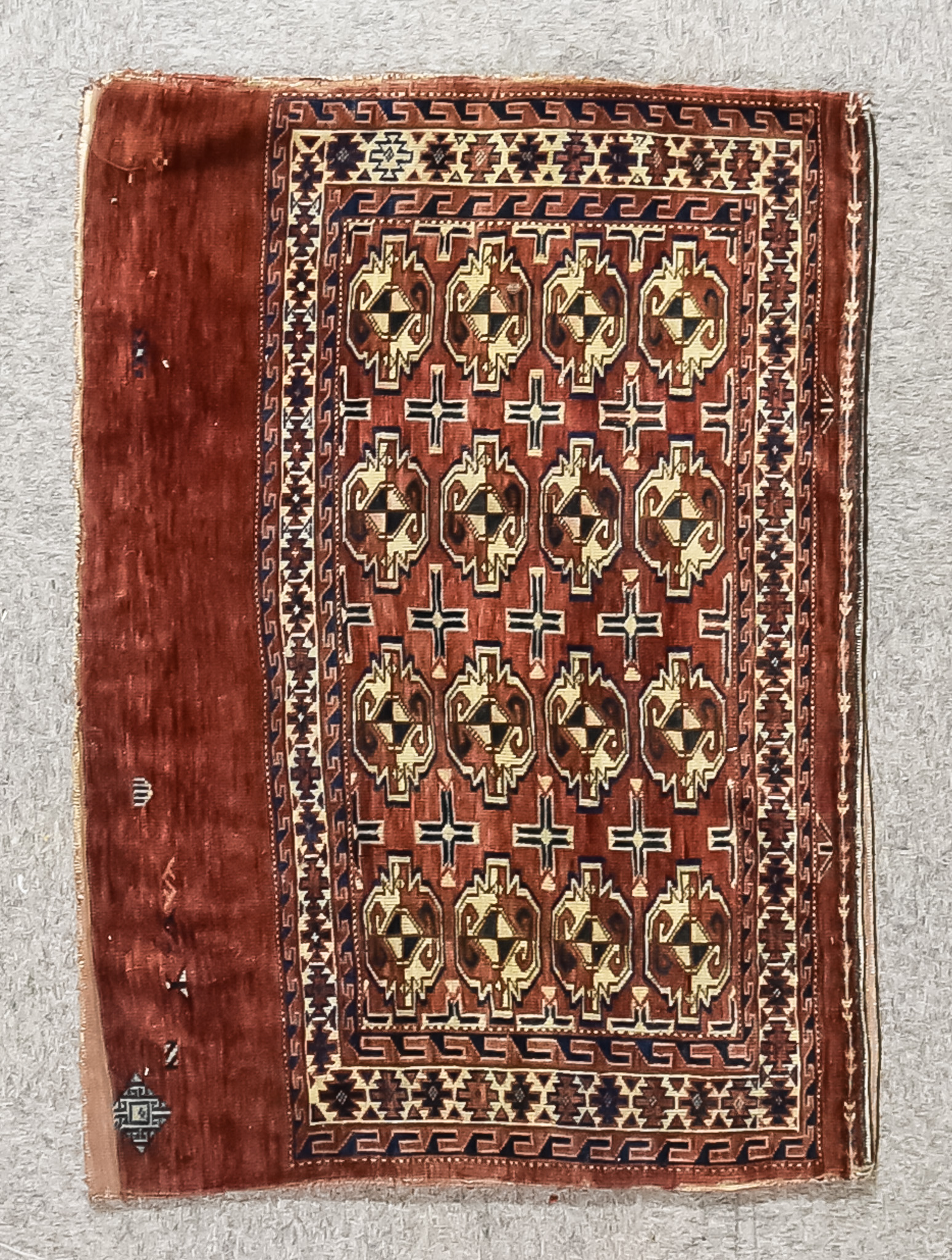 An Early 20th Century Turkeman Juval, woven in colours of ivory, navy blue and wine, the field