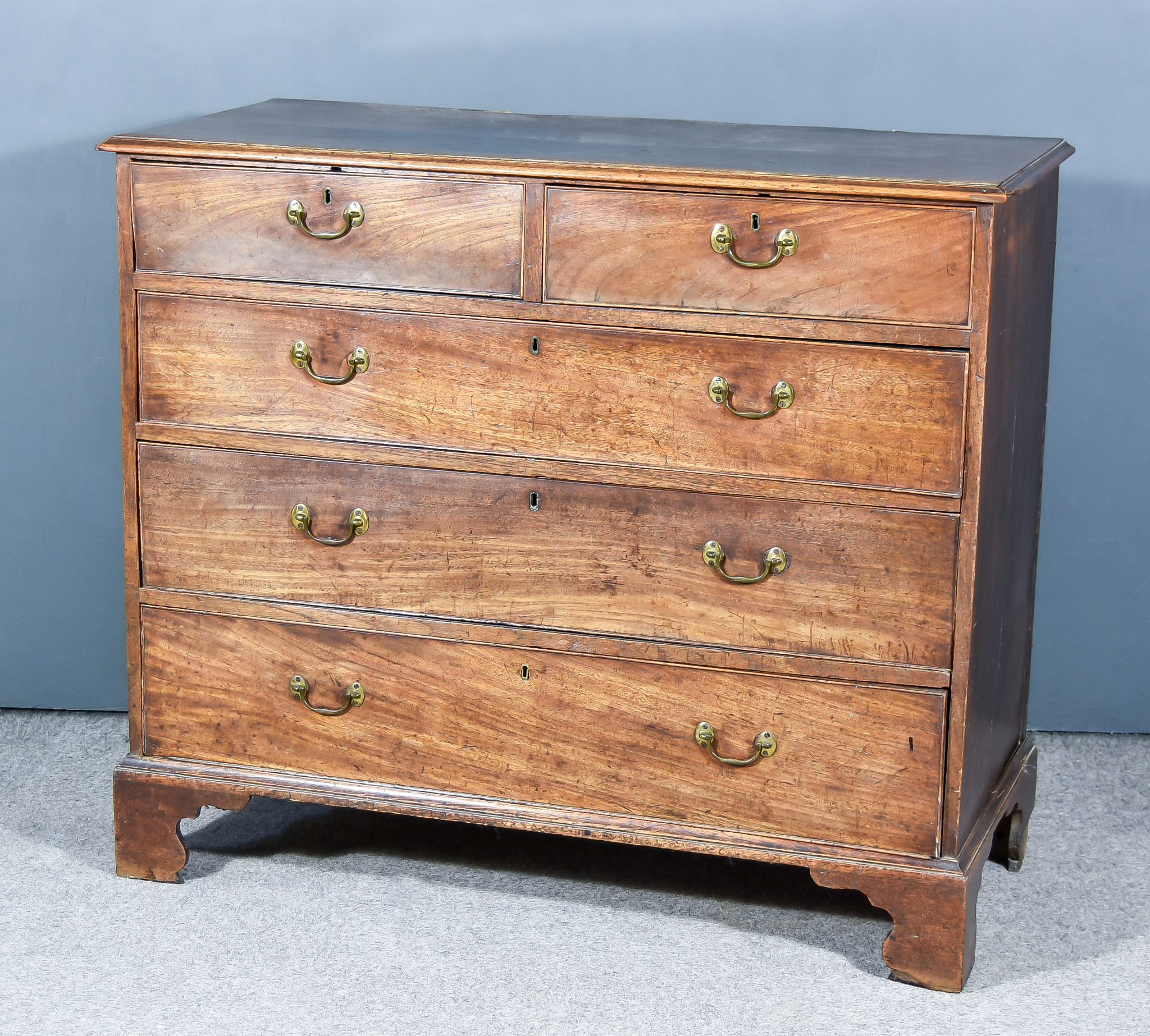 A George III Mahogany chest, with moulded edge to top, fitted two short and three long graduated