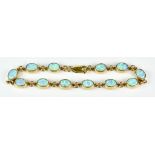 A 9ct Gold Custom Made Opal Line Bracelet, Modern, set with twelve opal stones, approximately 9mm