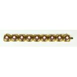 An 18ct Gold Pearl Bracelet, 20th Century, set with cultured pearls, each pearl surrounded by