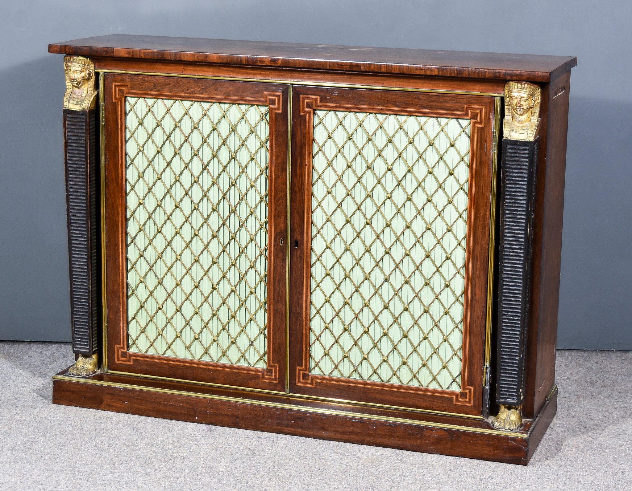 A Regency Rosewood and Gilt Metal Mounted Side Cabinet, with square edge to top, fitted two