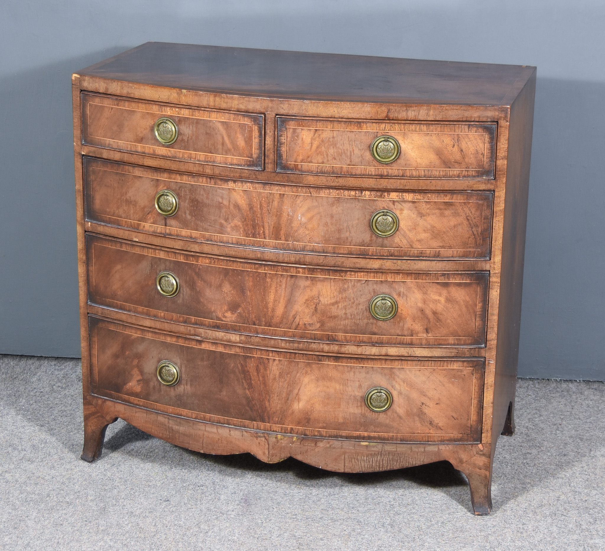 A Mahogany Bow Front Chest of Georgian Design inlaid with stringings and cross bandings,