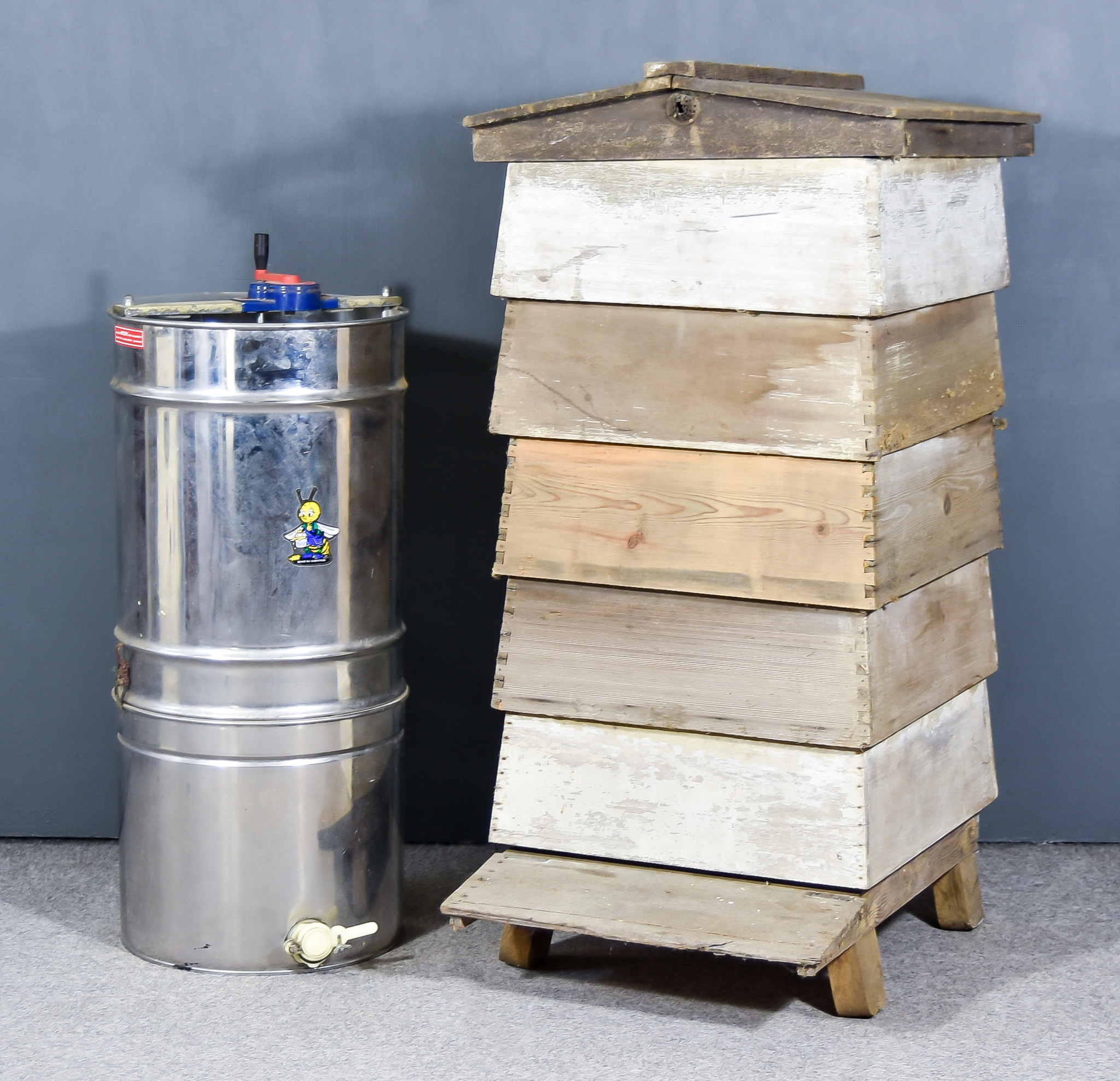 A Panelled Wood Five Tier Beehive, 24ins x 23ins x 48ins high and a stainless steel honey extractor