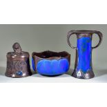 Three Pieces of Bretby Pottery, including a bronzed finish tobacco jar and cover of Art Nouveau