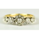 An 18ct Gold Diamond Cluster Ring, 20th Century, set with eleven small diamonds, approximately .75ct