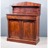 An Early Victorian Figured Mahogany Chiffonier, the angled back fitted one shelf, the base fitted