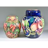 Two Moorcroft Pottery Ginger Jars, one decorated with Queen's Choice pattern on a navy ground,