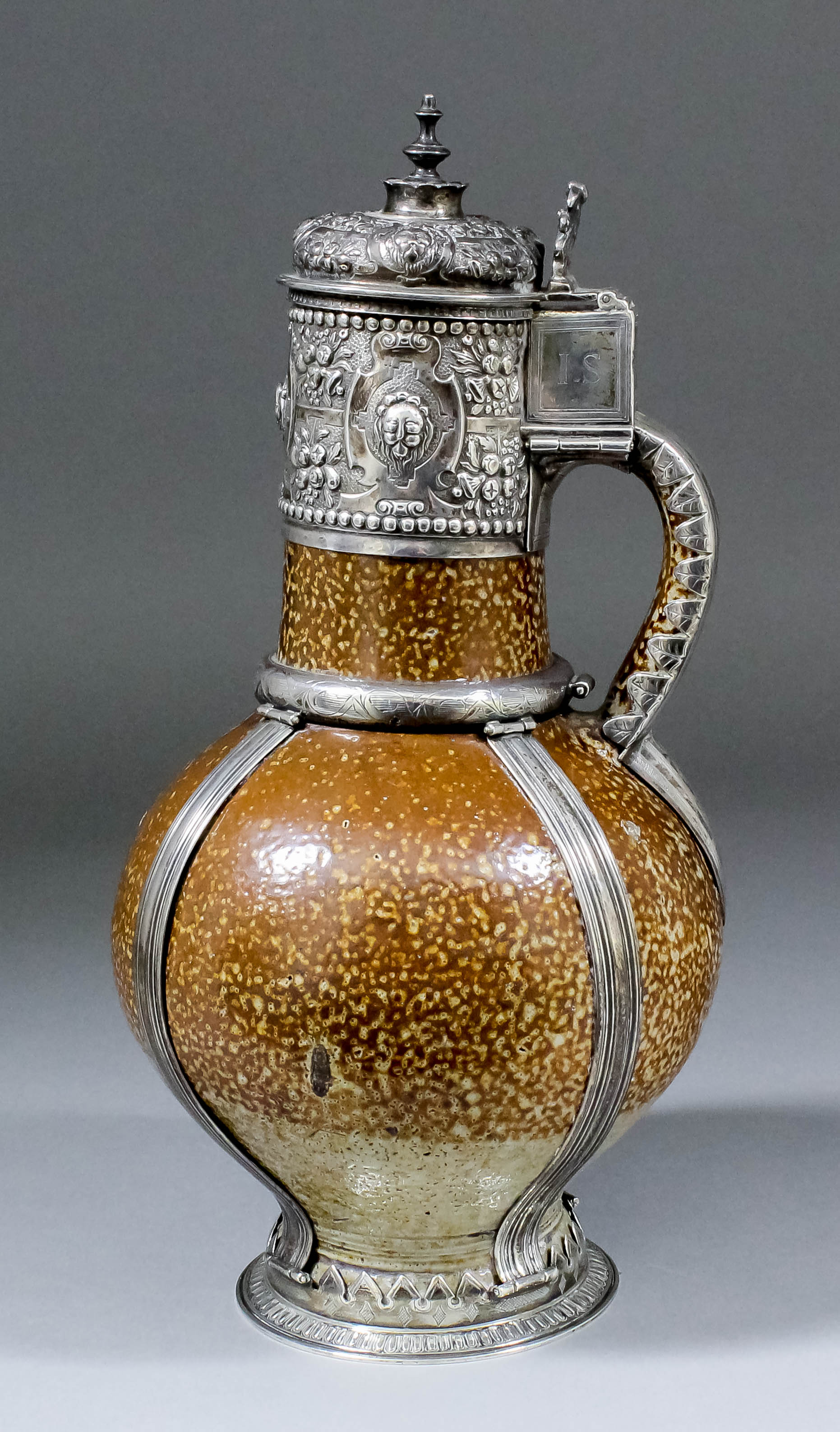 A 16th Century "Tiger Ware" Stoneware Jug, with later silver mounts, the neck mounts embossed and