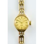 A 9ct Gold Lady's Manual Wind Wristwatch, by Acurist, 15mm diameter case, champagne dial with gold