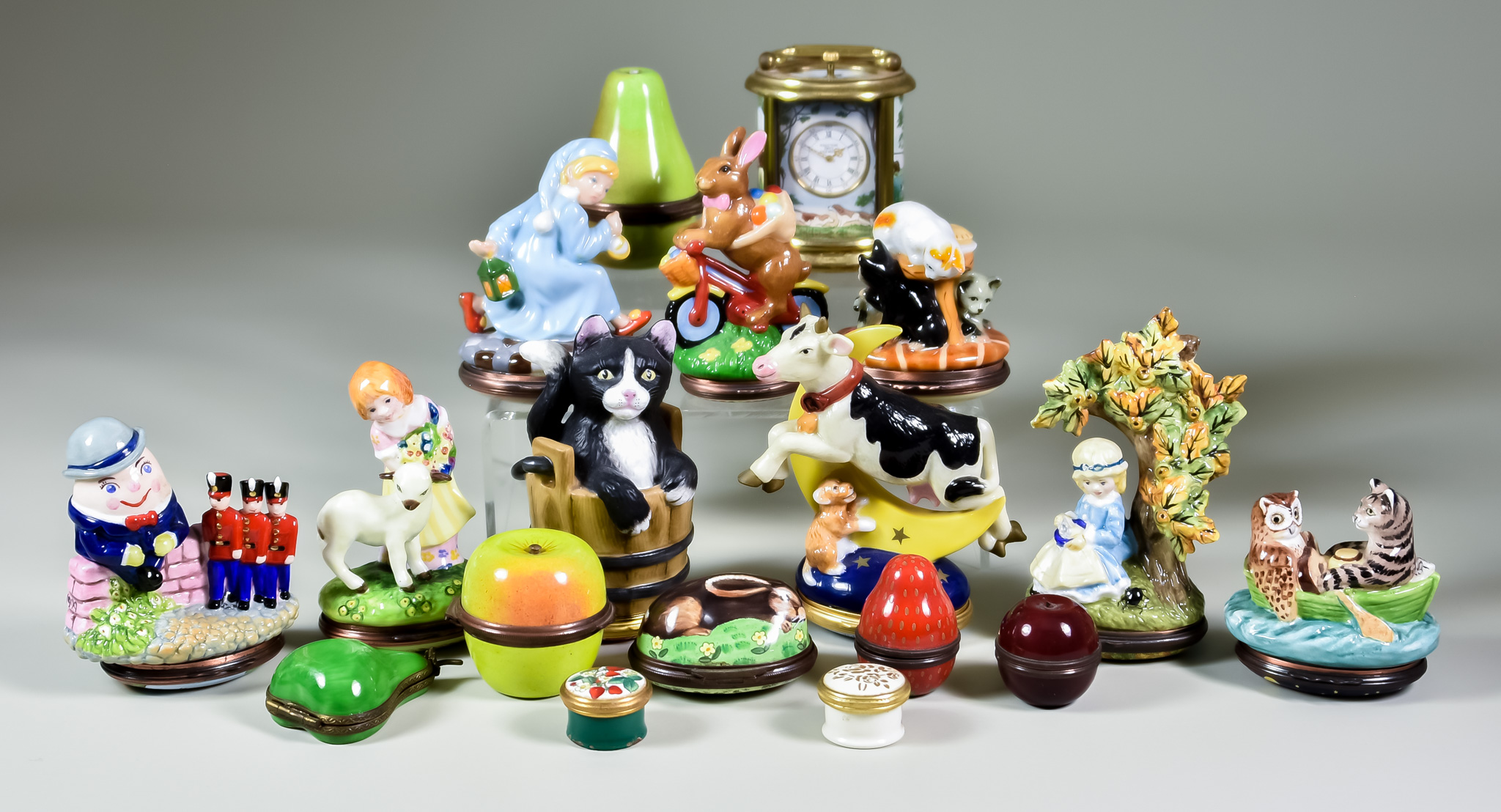 Seventeen Halcyon Days Bone China and Enamel Novelty Boxes and a Miniature Carriage Timepiece,