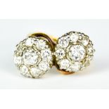 A Double Flower Head Diamond Ring, Early 20th Century, yellow metal set with double flower head,