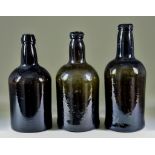 A Wine Bottle of Cylindrical Form of Olive Green Tint, Late 18th Century, with moulded string rim,