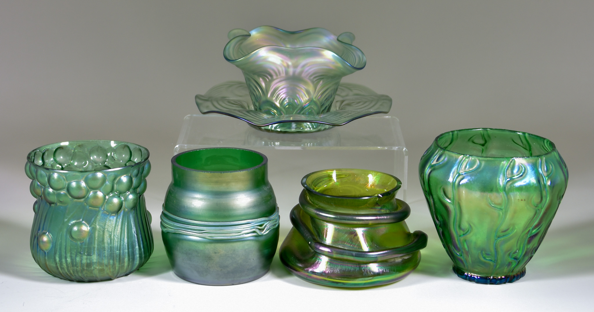 Six Pieces of Green Iridescent Glassware, including - a compressed vase in the Loetz Neptun