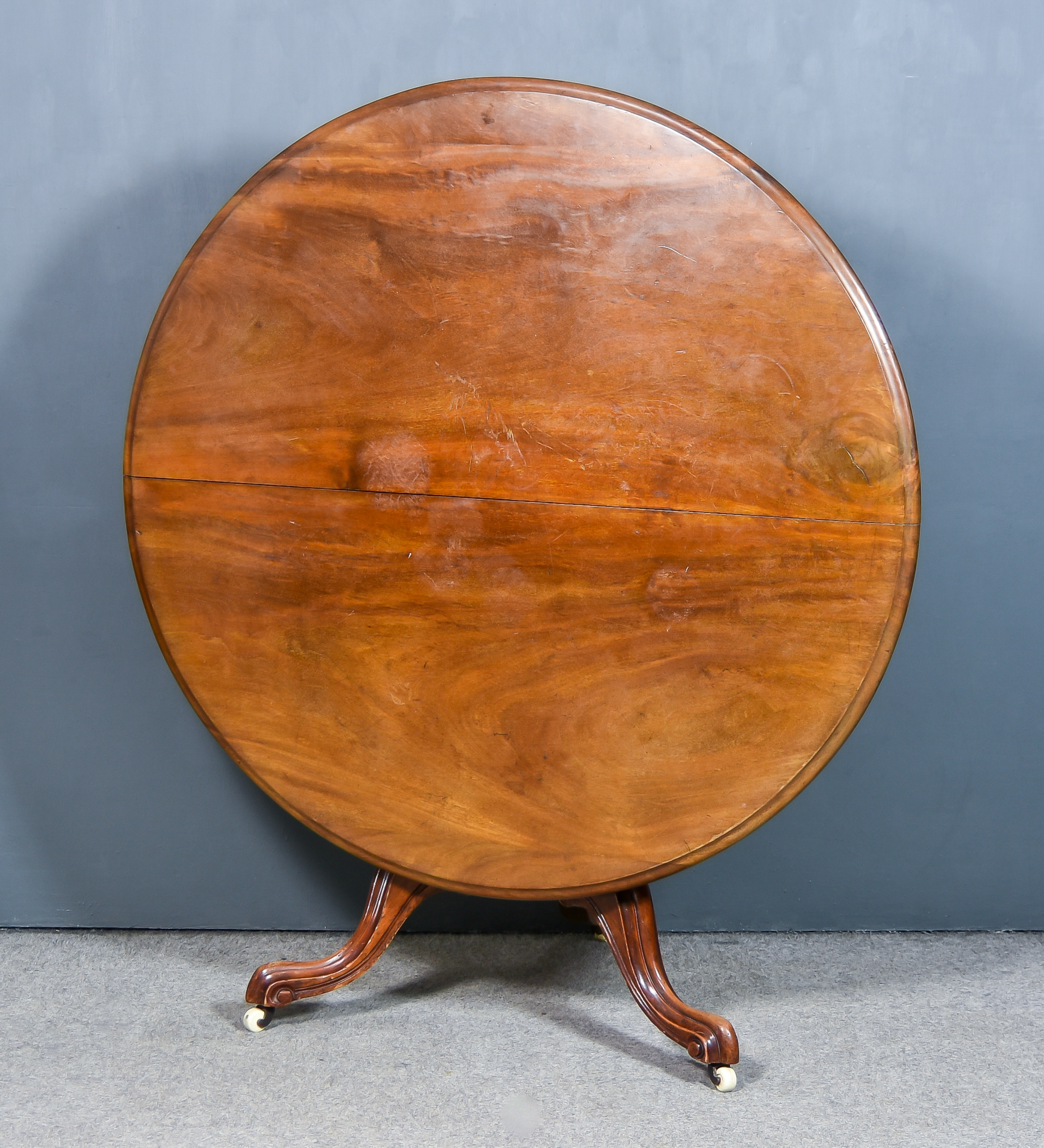 A Victorian Mahogany Circular Breakfast Table, with moulded edge to top, on turned central column