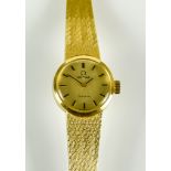 An 18ct Gold Lady's Manual Wind Wristwatch, by Omega, 18mm diameter case, champagne dial with