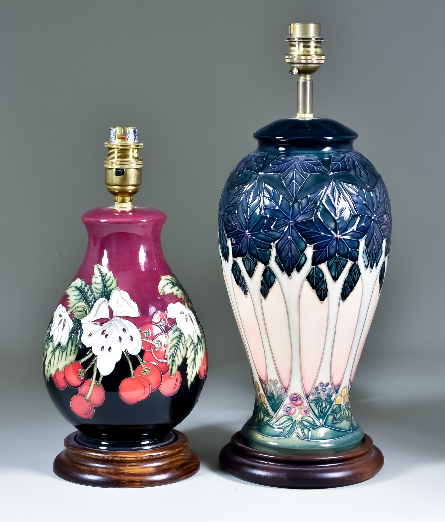 Two Moorcroft Pottery Table Lamps on Wooden Bases, one decorated in Cluny design on a pale pink