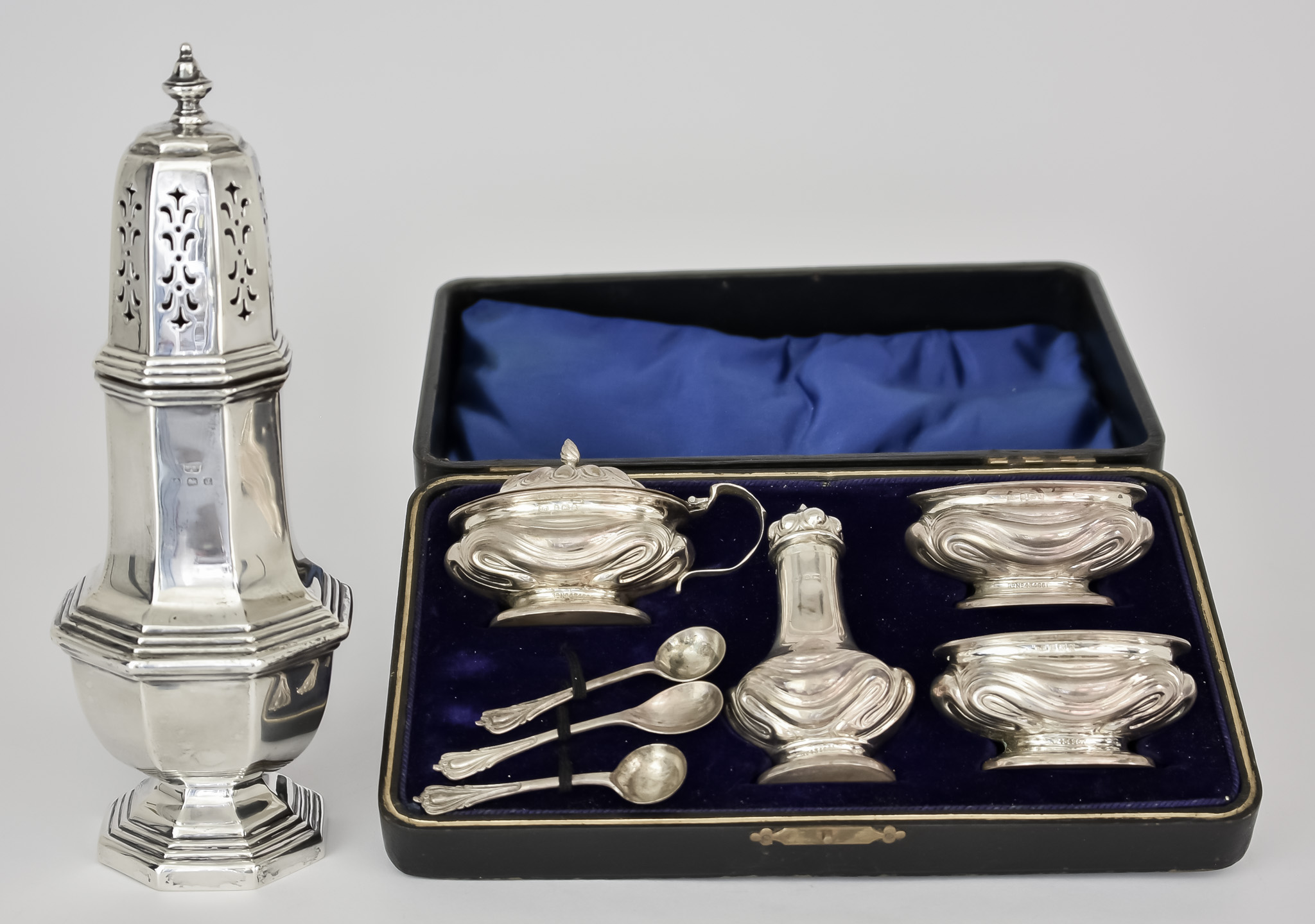 An Edward VII Silver Four-Piece Condiment Set and a George V Silver Sugar Caster, the condiment