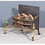 A Brass and Cast Iron Serpentine Fronted Fire Grate, the front with two pairs of turned finials