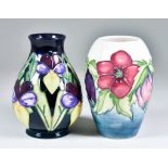 Two Moorcroft Pottery Vases, one baluster shaped vase decorated with Heartsease pattern on a navy/