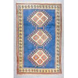 An Anatolian Rug of "Kazak" Design, woven in colours of terracotta, navy blue and fawn, with three