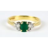A Three Stone Emerald and Diamond Ring, Modern, 18ct gold, set with a centre faceted emerald