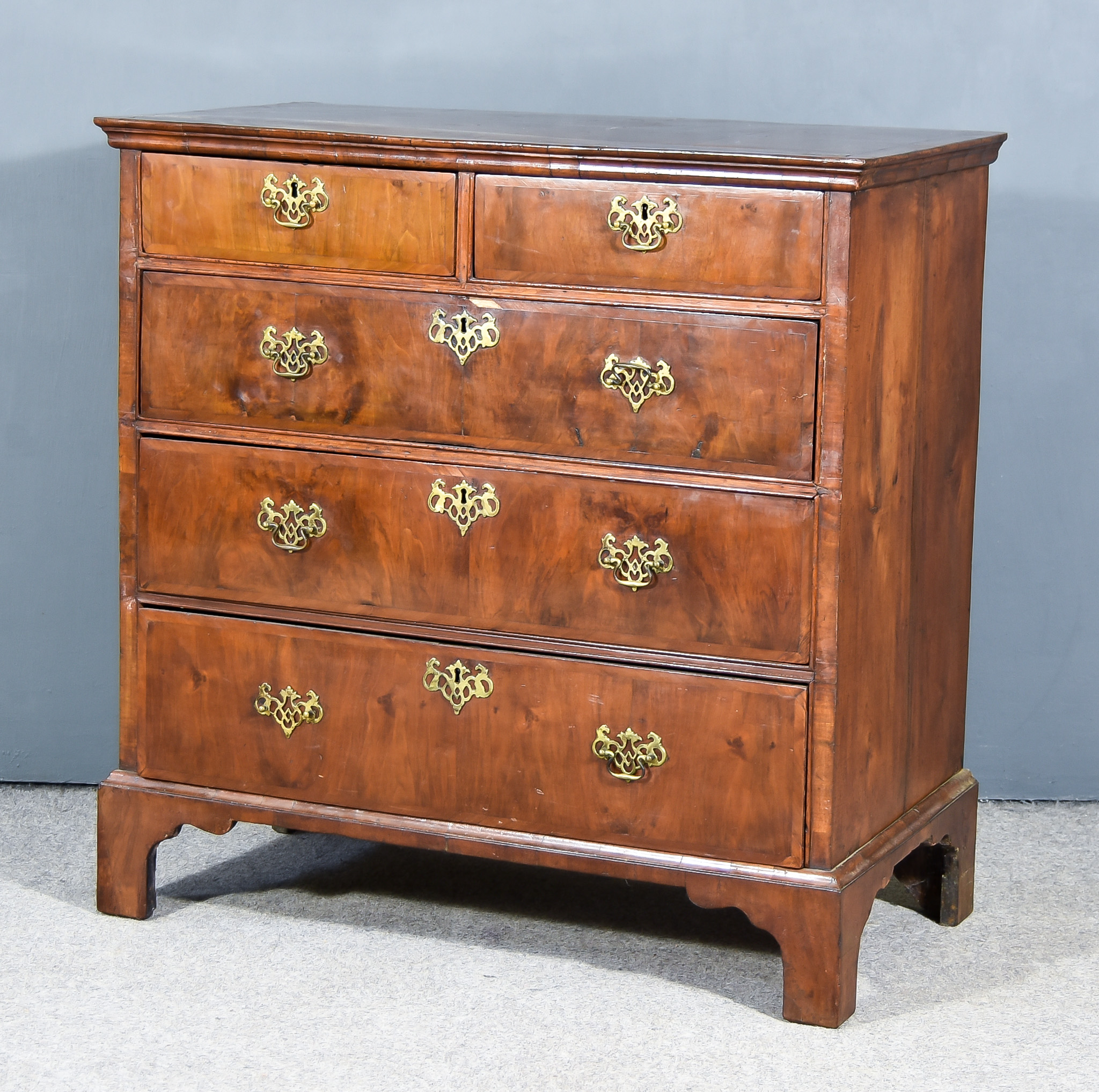 An 18th Century Walnut Chest, the top and front crossbanded and inlaid with bandings, with moulded