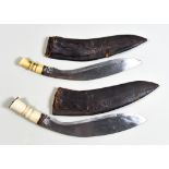 Two Early 20th Century Ghurka Kukri, both with bone grips and bright steel blades, one being