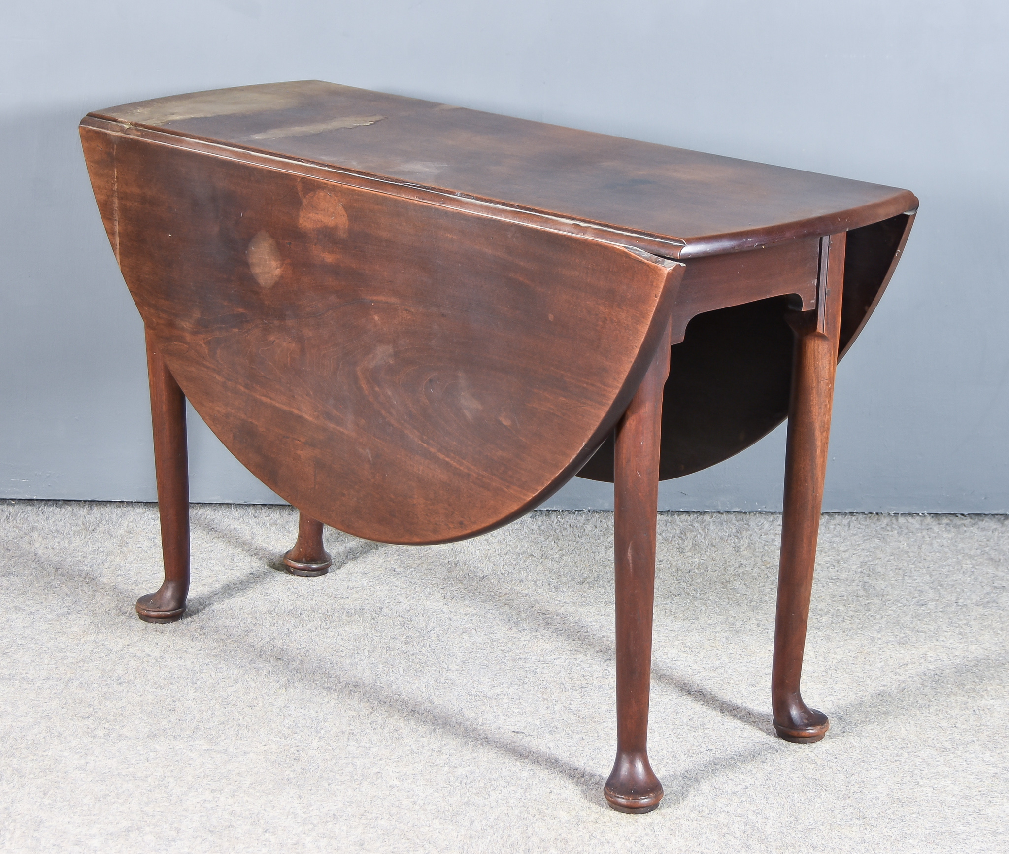 An 18th Century Mahogany Oval Dropleaf Cottage Dining Table, with plain top, on turned legs with pad