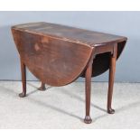 An 18th Century Mahogany Oval Dropleaf Cottage Dining Table, with plain top, on turned legs with pad