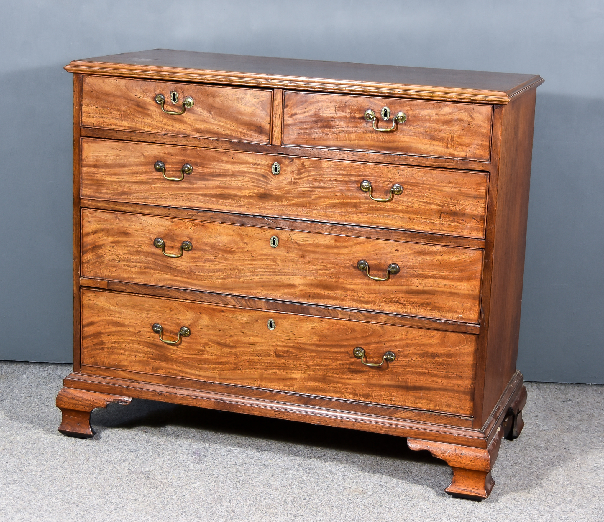 A George III Mahogany Chest, with moulded edge to top, fitted two short and three long graduated