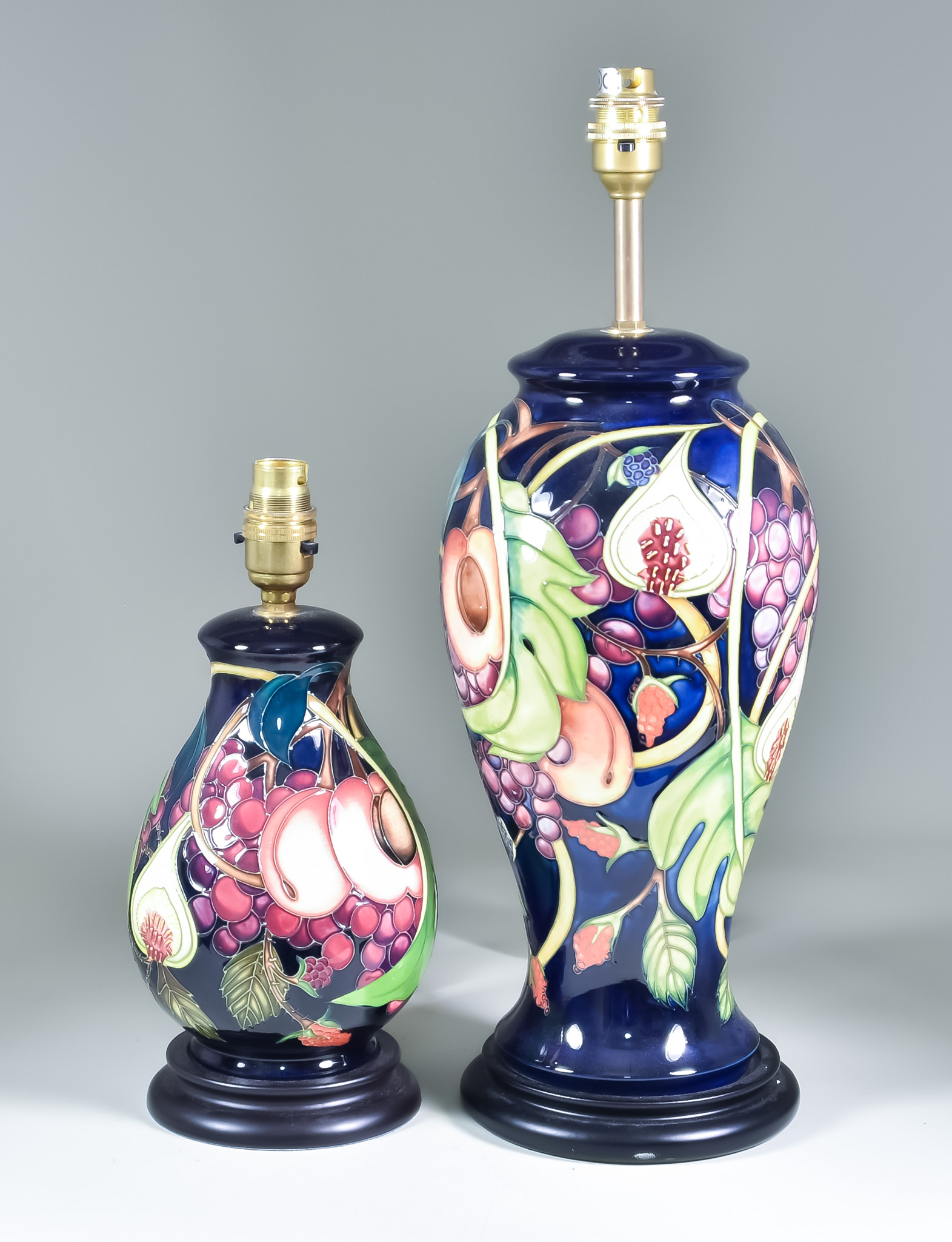 Two Moorcroft Pottery Table Lamps on Wooden Base, both decorated in Queens's Choice pattern, one