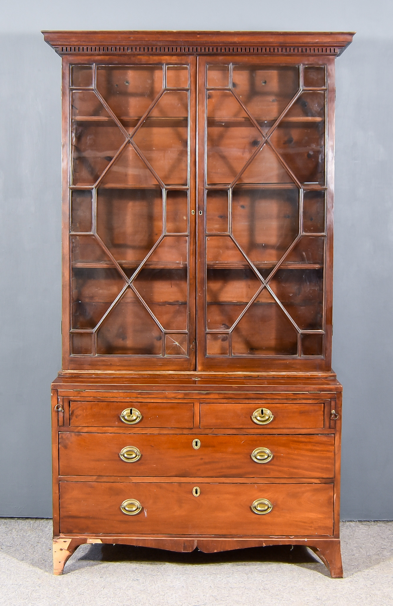 A 19th Century Mahogany Bookcase, the upper part with moulded dentil cornice, fitted three shelves