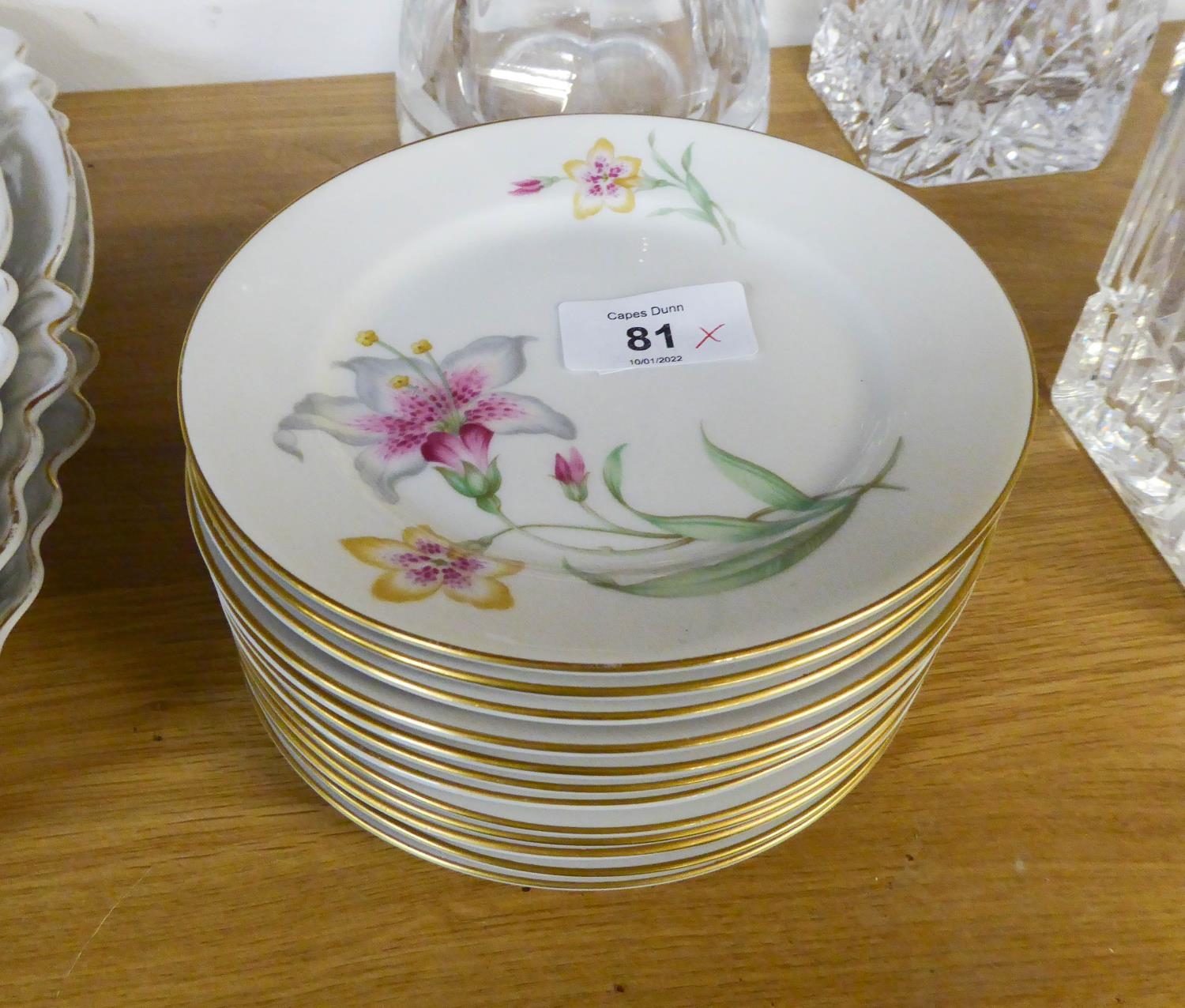 A SET OF 12 ROSENTHAL, GERMAN PORCELAIN SIDE PLATES, painted with lily sprays, 6? diameter