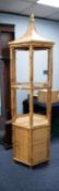 BAMBOO FRAMED AND WOVEN CANE PANELLED HEXAGONAL WHAT-NOT with cupboard base, mid-height glass shelf,