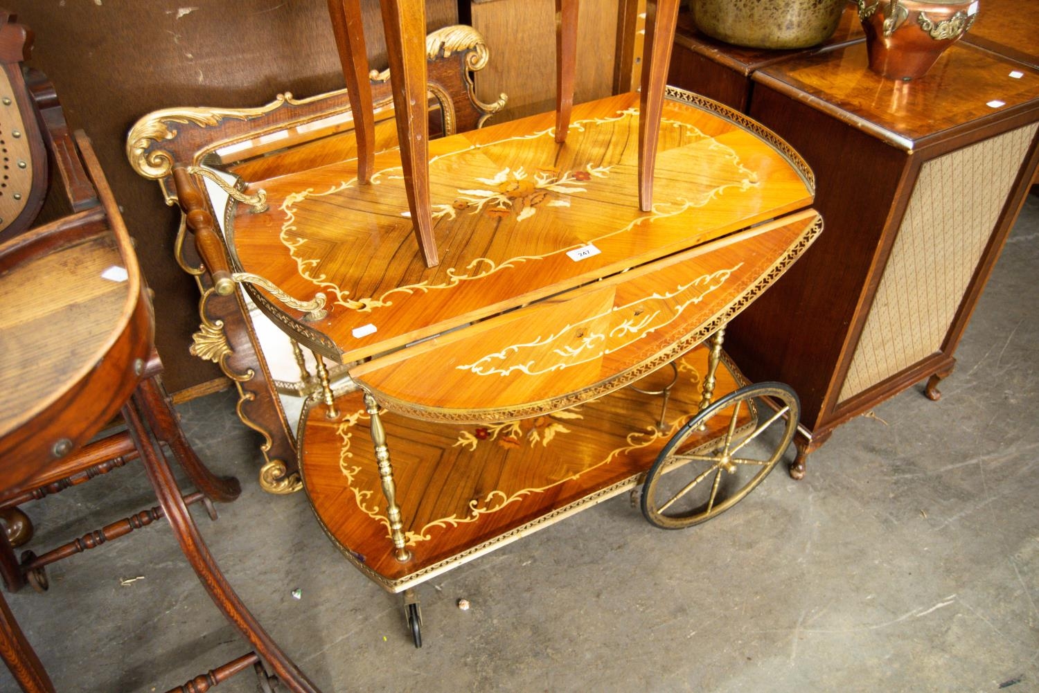 AN ITALIAN MARQUETRY TWO TIER COCKTAIL TROLLEY, HAVING FALL LEAVES