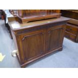 A MAHOGANY CHIPPENDALE STYLE SIDE CABINET WITH PLAIN LEDGE BACK, BLIND FRET CARVED FRIEZE, TWO