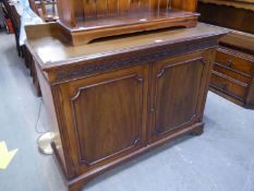 A MAHOGANY CHIPPENDALE STYLE SIDE CABINET WITH PLAIN LEDGE BACK, BLIND FRET CARVED FRIEZE, TWO