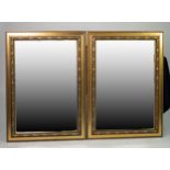 A PAIR OF RECTANGULAR BEVELLED EDGE WALL MIRRORS, IN EMBOSSED GILT CAVETTO FRAMES (3'5" X 2'6")