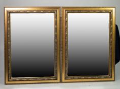 A PAIR OF RECTANGULAR BEVELLED EDGE WALL MIRRORS, IN EMBOSSED GILT CAVETTO FRAMES (3'5" X 2'6")