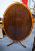 REGENCY PERIOD CROSS BANDED MAHOGANY OVAL TILT-TOP BREAKFAST TABLE with blondwood border and boxwood