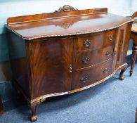 CHIPPENDALE REVIVAL MAHOGANY SERPENTINE SIDEBOARD, with low ledge back, three graduated centre