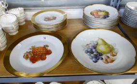 A SET OF SIX BAVARIAN CHINA FRUIT PRINTED dessert plates and a serving plate with broad gilt rims; a